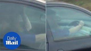 Motorist spotted driving down motorway with newspaper at the wheel - Daily Mail