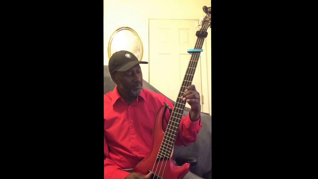 Gospel Bass guitar upright style with a capo. Watch out church coming