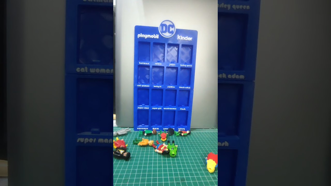 Playmobil DC Kinder display stand. With booklet holder and clip-on stand for displaying the figures.