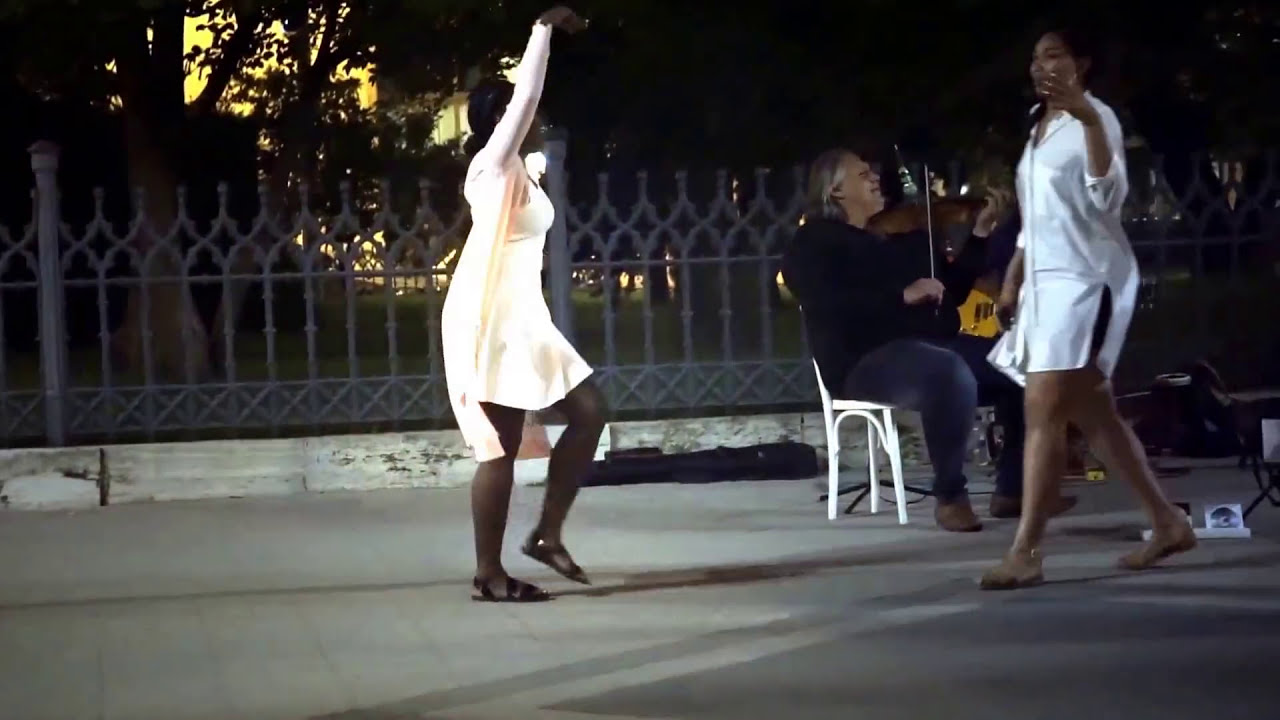 Dancing black women & white students dance on the road to a diff/ version of Black Magic Woman!