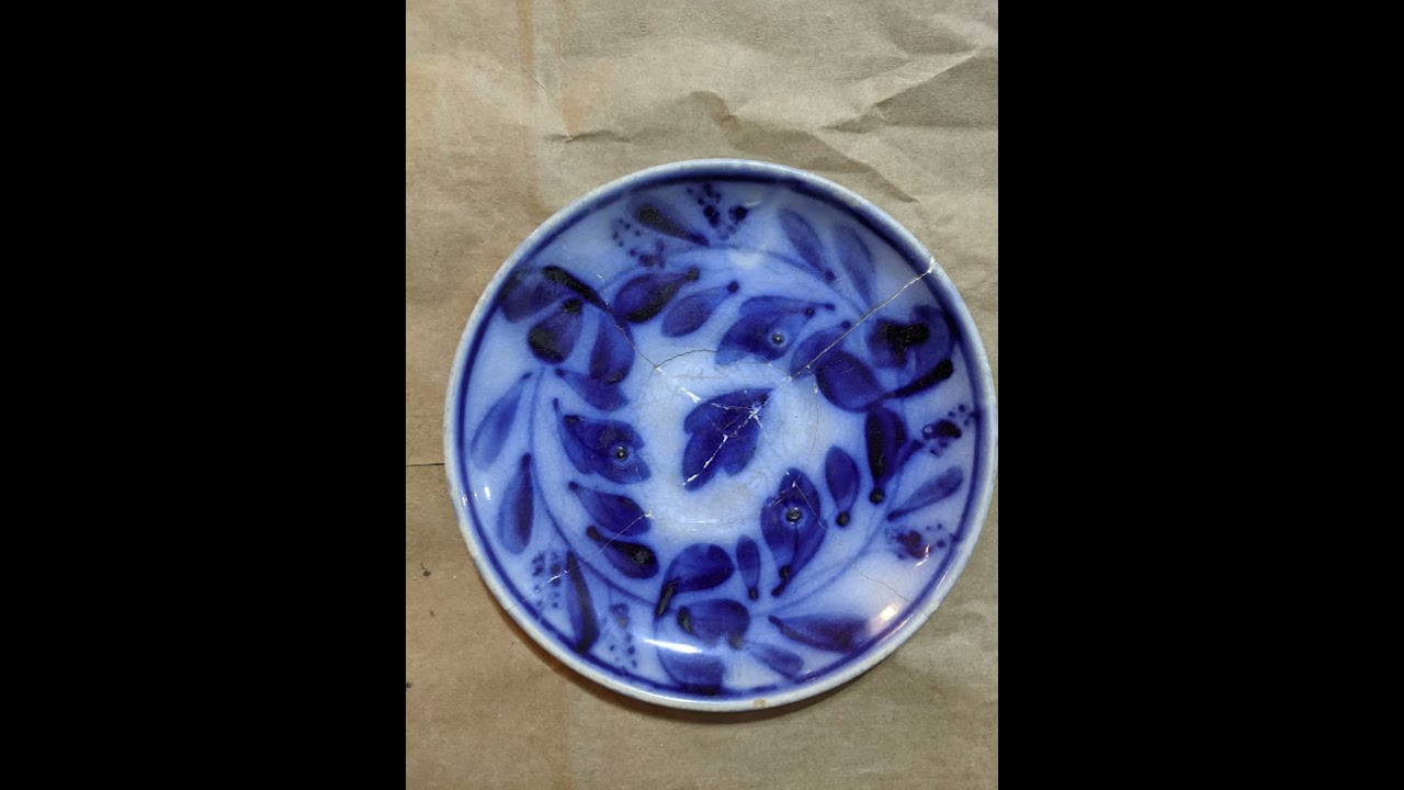 Broken pieces; cosmetic restoration of a smashed antique flow blue saucer
