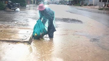 Removing the Trash In Culvert Drain On Street Satisfying Clogged Drain