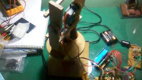 Robotic Arm Made out of wood Servomotors, with a PS2 controller and a pic16f877a (80%)