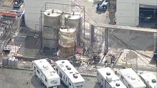 Water no longer being sprayed, crews seen climbing OC chemical tank