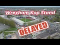 Ryan reynolds and rob mcelhennney hit a setback as wrexham fc kop stand delayed