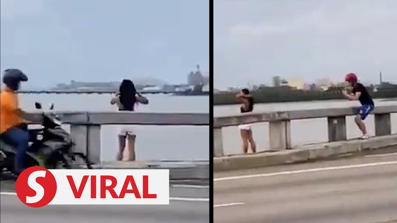 Tourist poses over Penang Bridge parapet, stuns motorists