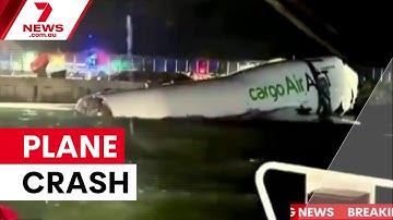Cargo plane crashes at Hong Kong airport | 7NEWS