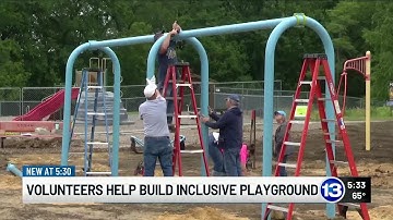 Volunteers help build new inclusive playground