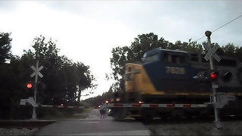 CSX Long Mixed Freight Train At Railroad Crossing