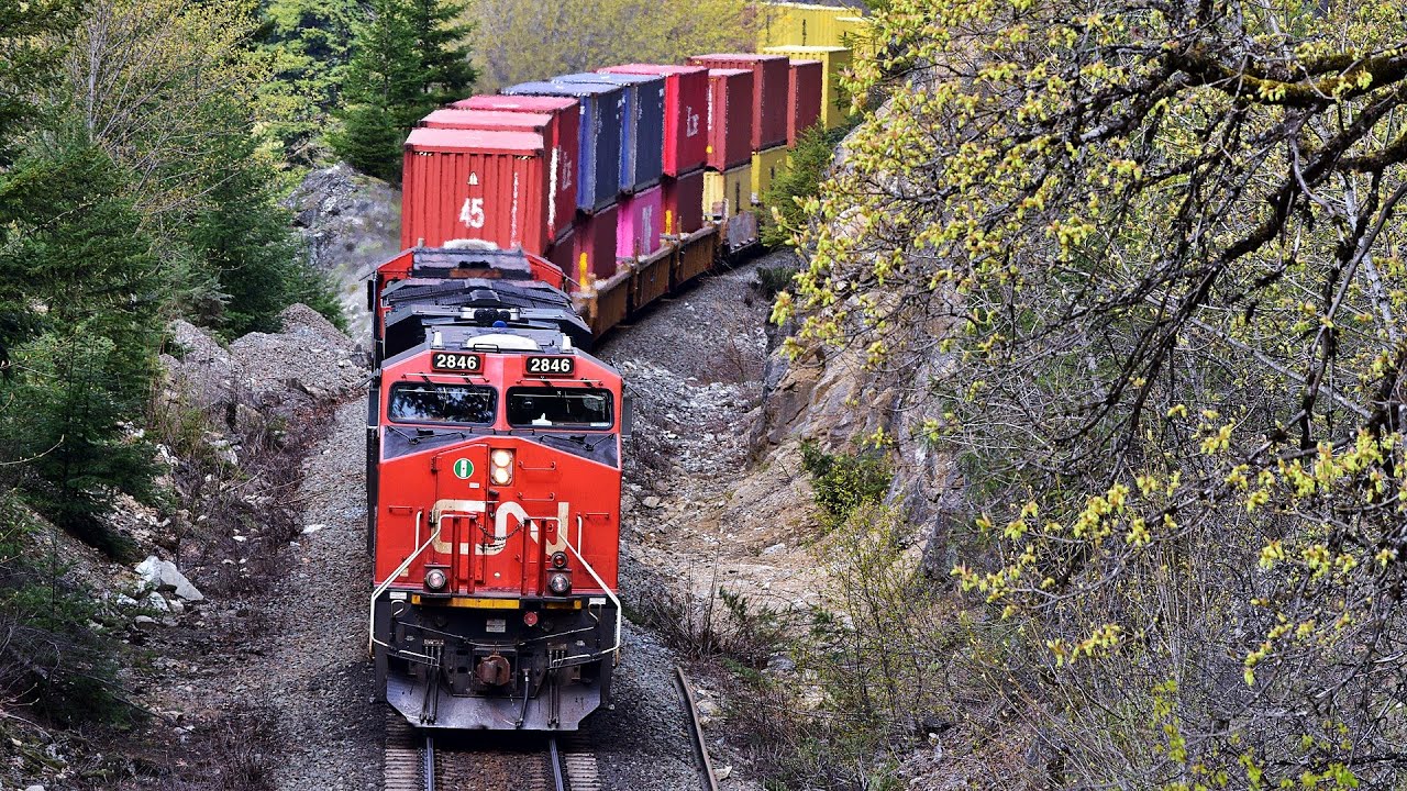 OVERLOAD OF TRAINS Through Sharp Curve Into Mountain Tunnel Along The Fraser River, CANADA