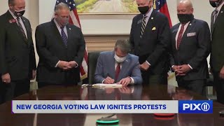 State rep arrested as GA governor signs voting law