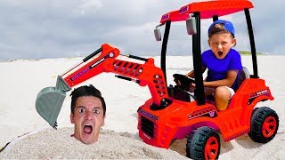 Senya and daddy playing with a tractor on the beach. Funny stories for kids