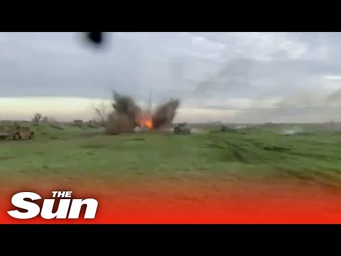 Ukrainian troops jump from tanks and fan out after being hit by Russian bomb.