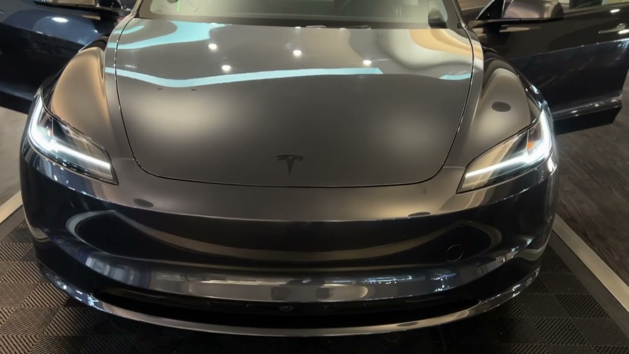 A snapshot of the American economy, featuring a Tesla inside a dying shopping mall