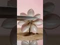 Macro blade slices flower-shaped kinetic sand; petals reset in infinite smooth loop.
