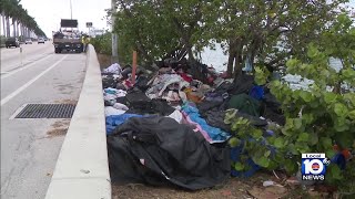 Crews with FDOT arrive along MacArthur Causeway to clear out mounds of trash