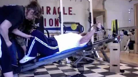 Debra Howard doing upper body exercises on total g...