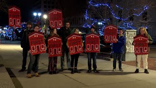 Demonstrators outside Lansing City Hall push for improvements to new warming center
