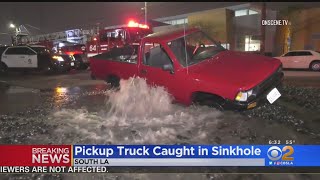 Water Main Break Opens Up Sinkhole That Nearly Swallows Pickup Truck