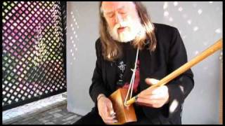 Scott Ainslie plays cigar box guitar at the Ships of the Sea Museum