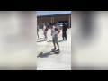 Guy Riding Hoverboard Outside of School Falls on Head