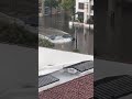 Tesla plows through flooded san diego street