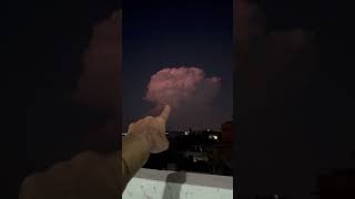 Towering lightning storm cloud illuminates the night sky in Fateh Jhang, Pakistan
