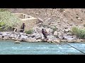 Hard work of nomadic family in summer building a canopy by the river to save from the heat