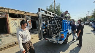 Agha Ghorban’s trip to the city; purchasing doors and windows, painting doors, and buying supplies.