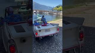 Several Amphicars sail into lake after street drive in Luino, Italy