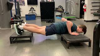 Isometric Push-Up feet elevated hands on boxes