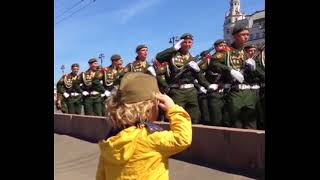 Russian soldiers give a military greeting to the little girl