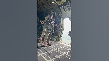 Army Jumpmaster jumping from C130 with Paratroopers