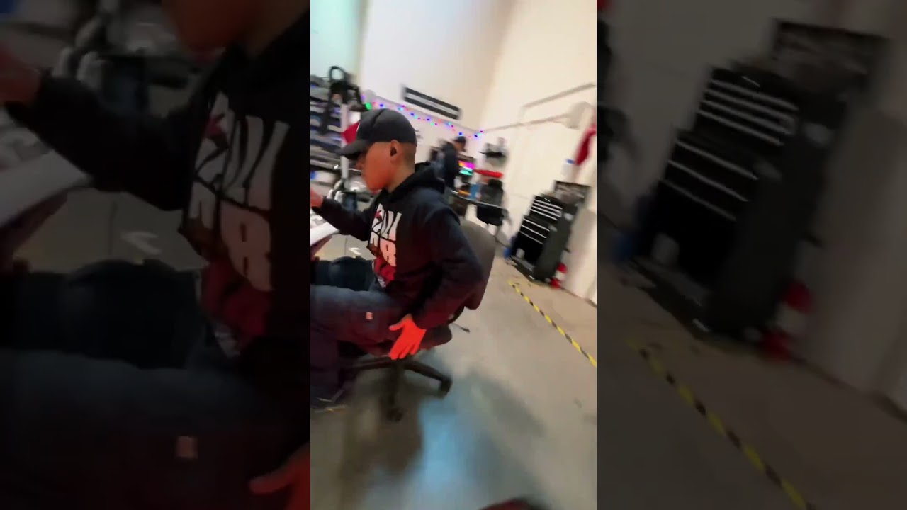 A technician working on a scooter on the service floor
