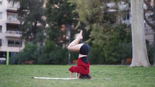 Girl Doing Yoga In Park. With Head Stand Yoga Pose.