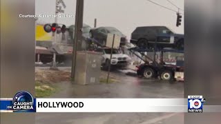 Train crashes into car carrying trailer stuck on tracks in Hollywood