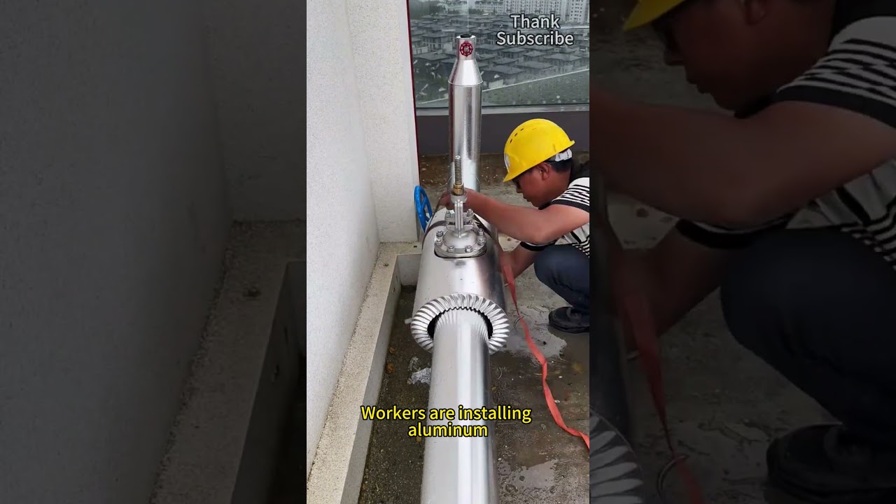 Workers are installing aluminum insulation valve boxes on pipelines