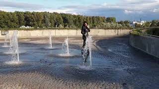 Granate styling, walking through a fountain, nice scenery, thigh high boots, leather jacket