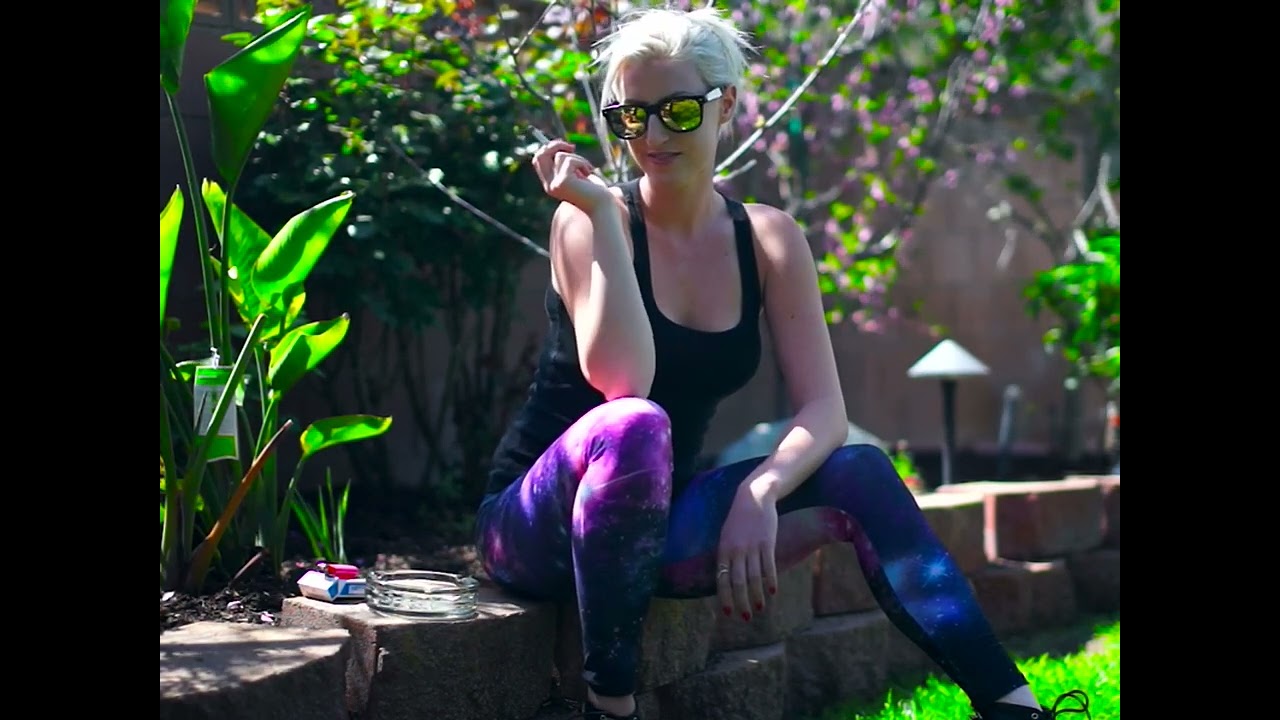 Pretty girl smoking in galaxy pants