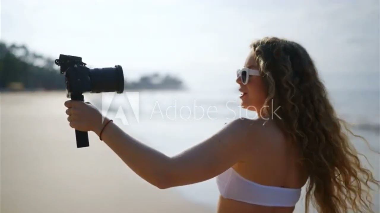 Paid stock Video of a Girl talking on camera wile walking on the beach