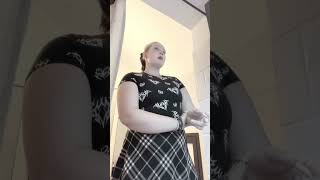 girl in skirt smoking cigarette on her balcony