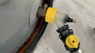 How to remove calcium from a water heater tank utilizing two points of agitation