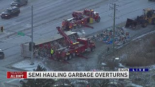 Semi hauling trash overturns in Elgin