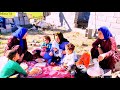 Hard work the effort of a nomadic widow and her children to fix the floor of the house