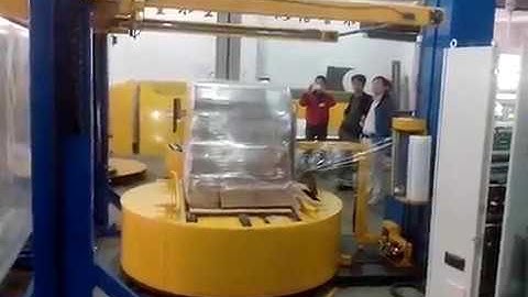 Automatic turntable pallet wrapping machine with top sheet convering