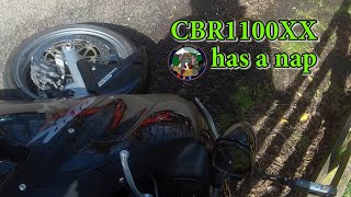 Bike falls over.