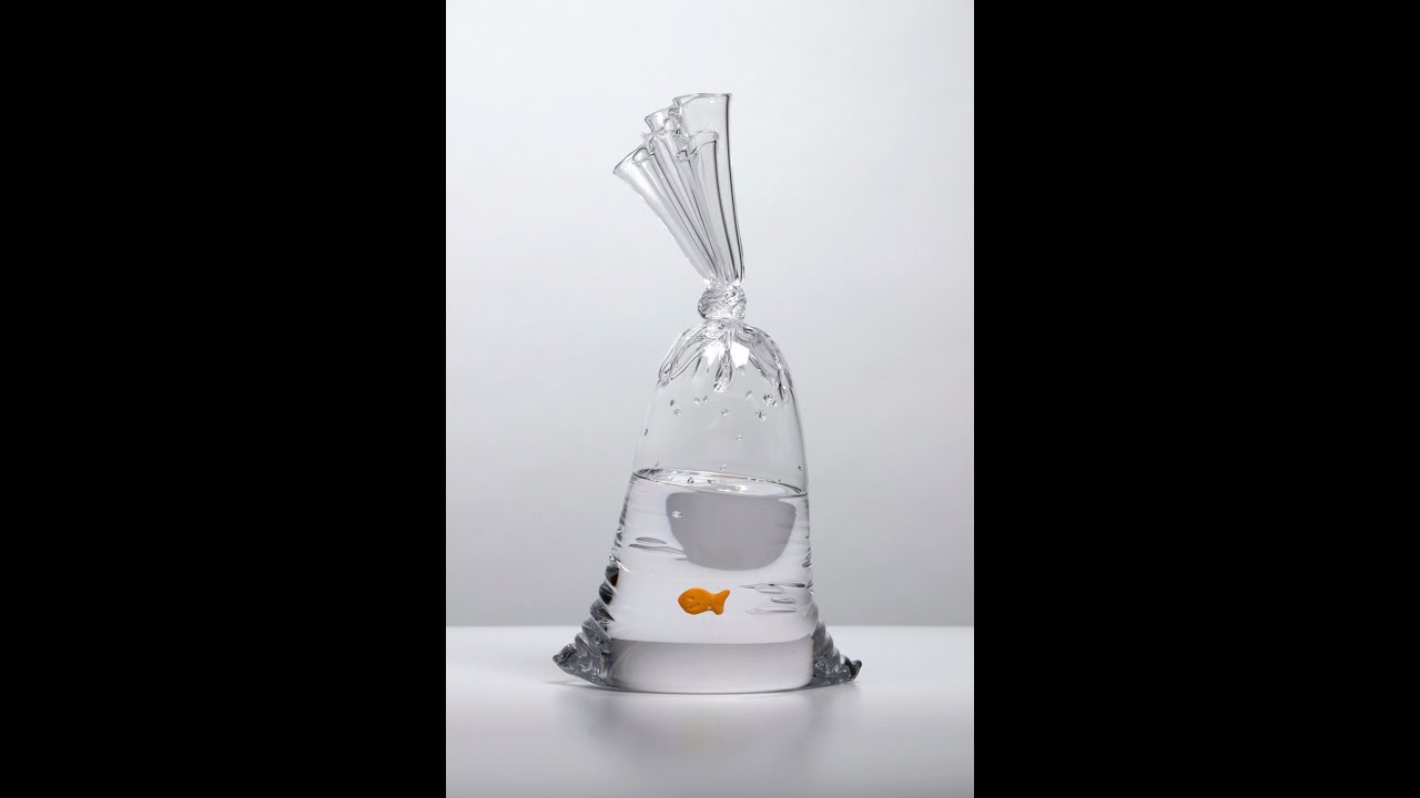 Hyper-Realistic Glass Sculpture with a Goldfish Cracker Swimming Inside.