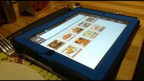 Nishant picking his favourite dishes in a restaurant using Avaz AAC app