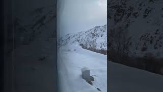 Watching snow-covered mountains pass by through a train window feels like a dream.