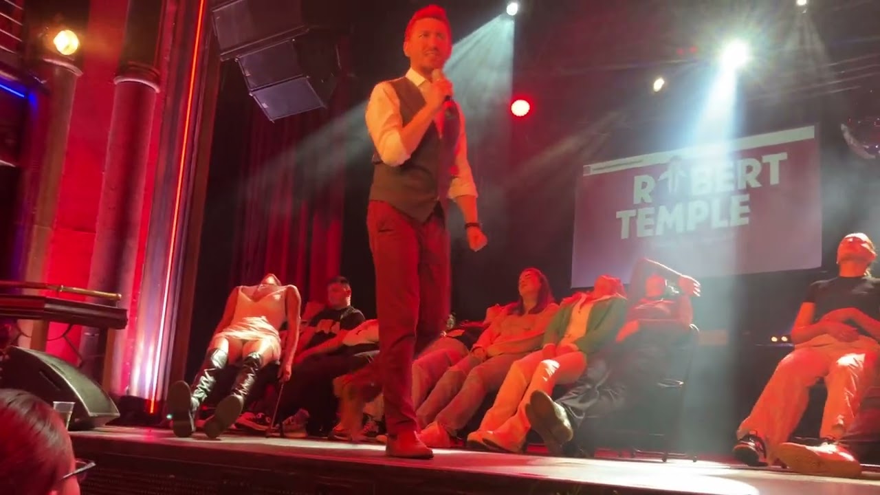 Hypnotized People in the beach, stretching, dropping things off. Robert Temple hypnosis show London